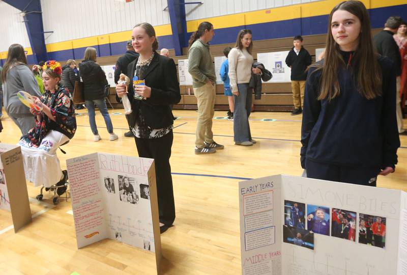Logan Jr. High sixth-grade students (from left) Emerson McCauley as Georgia O'Keeffe, Oakley Sprague as Ruth Handler and Brooklin Cain as Somone Biles give speeches during a lige Wax Museum on Thursday, Feb. 26, 2026 at Logan Jr. High School in Princeton.