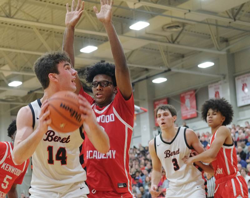 Benet’s Parker Sulaver (14) looks to get past Kenwood's Calvin Robins Jr late in a "When Sides Collide" invitational game on Jan. 21, 2023 at Benet Academy in Lisle.