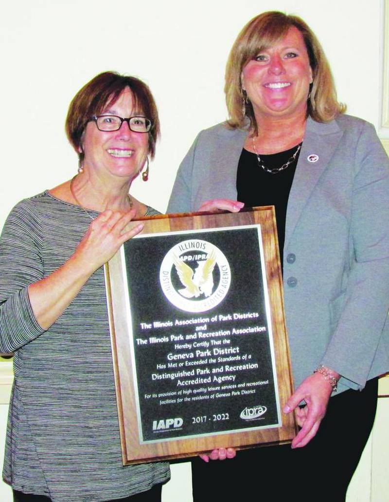 From left, Geneva Park District Board President Susan Vanderveen and Executive Director Sheavoun Lambillotte receive a plaque denoting the district's achievement as an Illinois Distinguished Accredited Agency by the Illinois Association of Park Districts and the Illinois Park and Recreation Association.