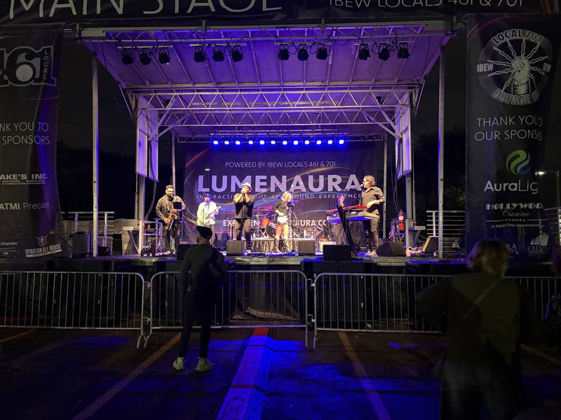 Motown Nation performs during LUMENAURA in Aurora Oct. 10, 2025. A star and installations from Lumenaura light up downtown Aurora Oct. 10, 2025. Lumenaura is described as a light and sound experience and runs through Oct. 26.