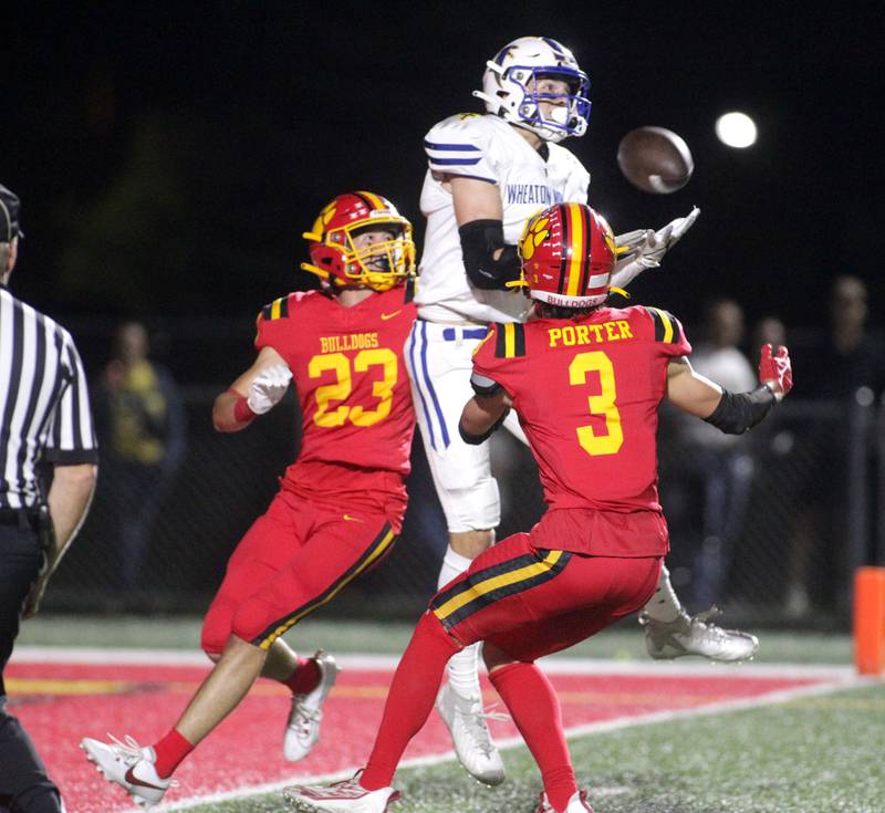 Wheaton North’s Rich Schilling (center) makes a catch for a touchdown surrounded by Batavia’s Josh Kahley (left) and Kyle Porter (right) during a game at Batavia on Friday, Sept. 22, 2023.