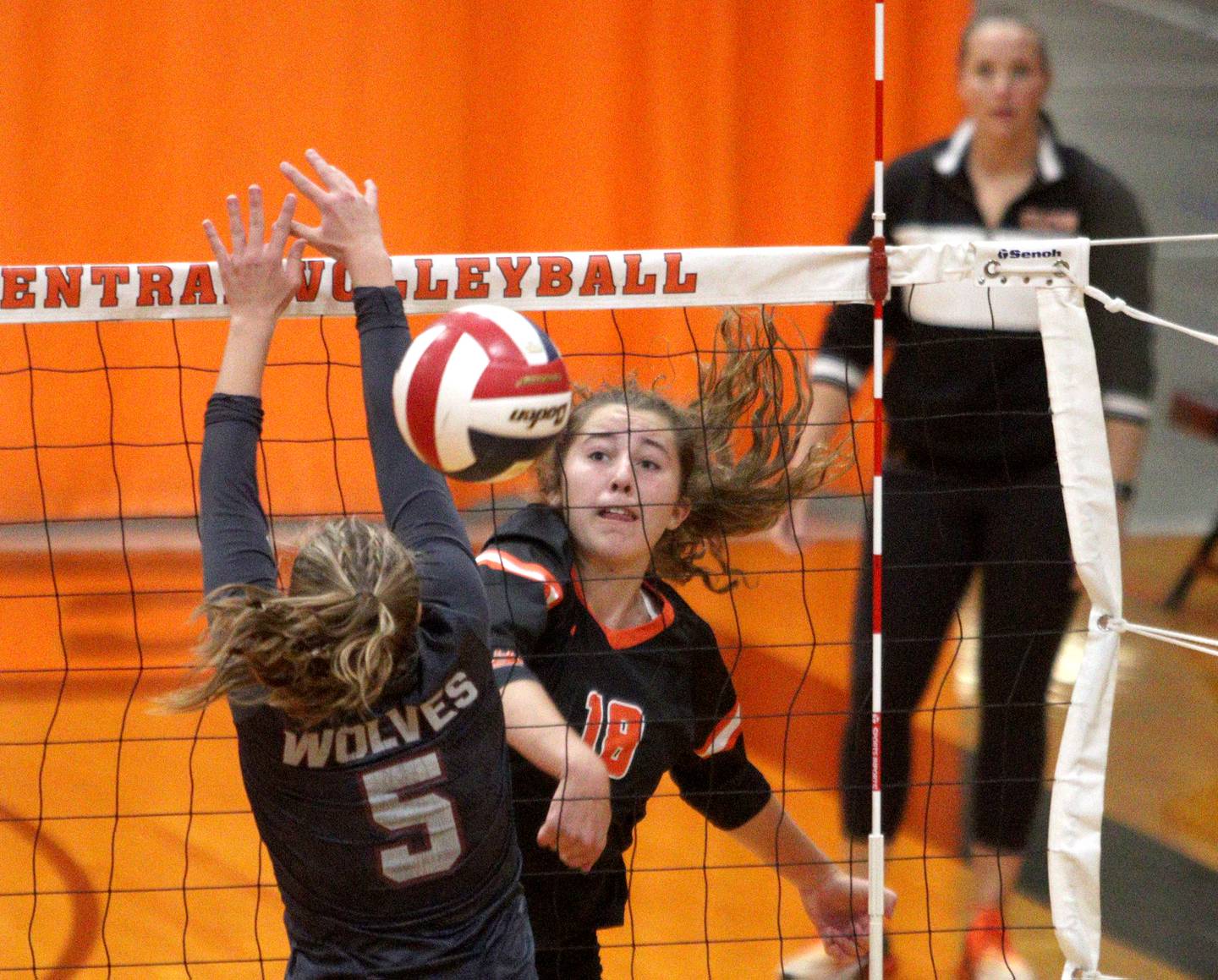 Crystal Lake Central’s Anna Starr sends the ball past Prairie Ridge’s Grace Jansen in varsity volleyball at Crystal Lake Central Thursday night.