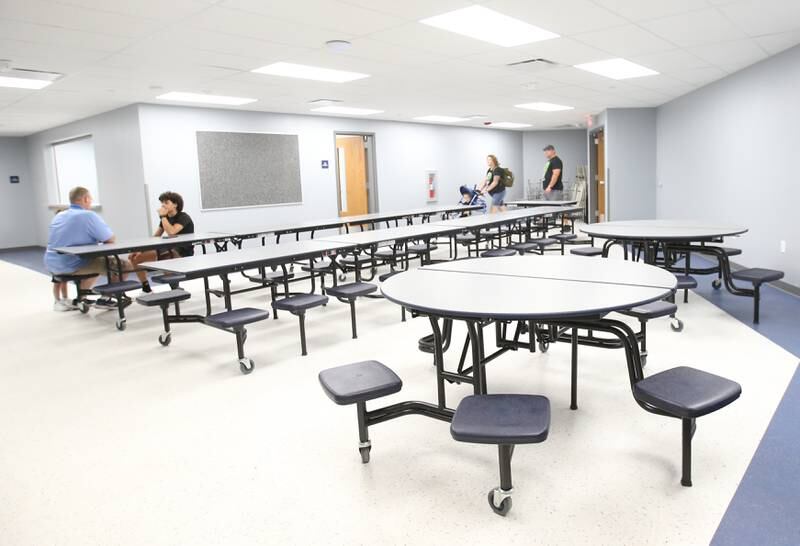 Visitors tour the new cafeteria at the Lighted Way building during the ribbon cutting and dedication on Saturday, Aug. 5, 2023 in La Salle.