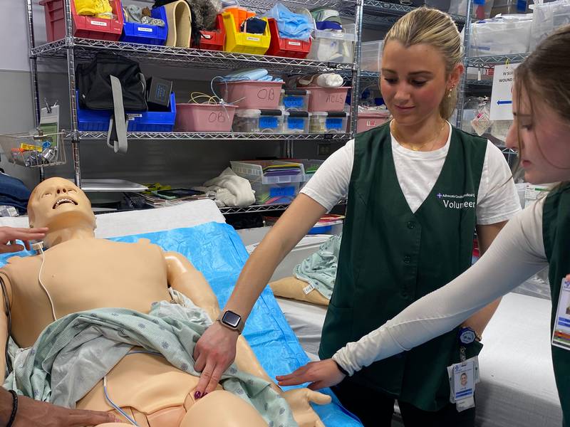 Chloe Miller locates the femoral pulse on the simulation mannequin