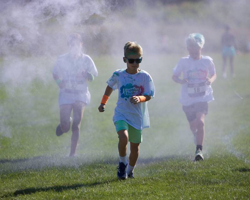 Kids run through the colors at the Glen Ellyn 2K Kids Color Bash Run on Saturday Aug.10, 2024 at Ackerman Park in Glen Ellyn.