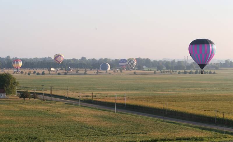 Hot air balloons fly over Zearing Park for the 52nd annual Homestead Festival on Saturday, Sept. 9, 2023 in Princeton.