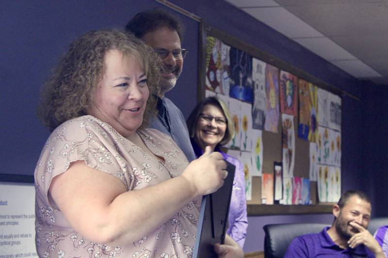 Kimberly Munson, a teacher at Dixon High School, and Steve James, maintenance department, are honored as Dixon Public Schools employees of the year. Sarah Wilson, who was not in attendance, also was recognized. At right, board president Linda Wegner and board secretary Brandon Rogers.