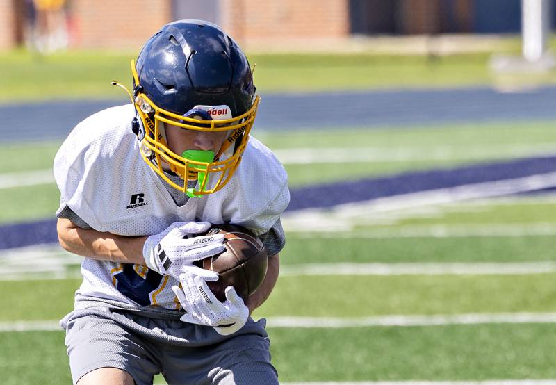 Sterling’s Wyatt Fink hauls in a pass Monday, August 11, 2025, for the first day of football practice.
