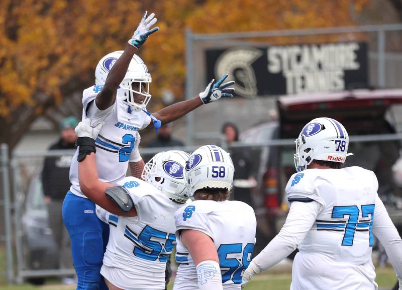 St. Francis' Ian Willis gets a lift after scoring a touchdown from teammate Frank McMillen Saturday, Nov. 16, 2024, during their Class 5A quarterfinal game against Sycamore at Sycamore High School.