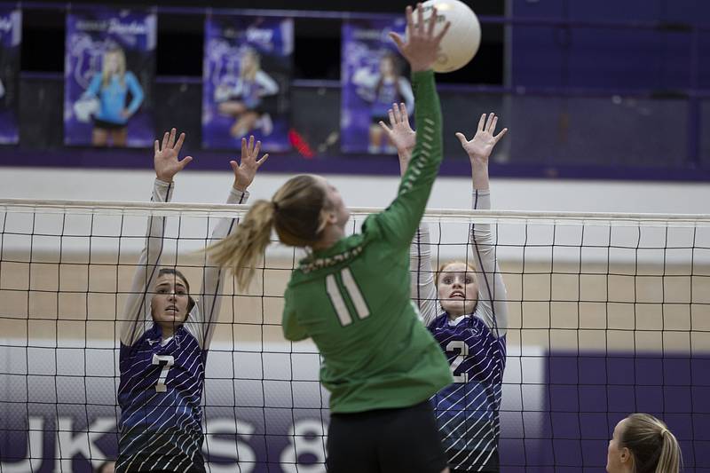 Dixon’s Sydney Hargrave (left) and Madyson Tichler go up to block a shot by Geneseo’s Elizabeth Rapps Monday, Oct. 17, 2022.