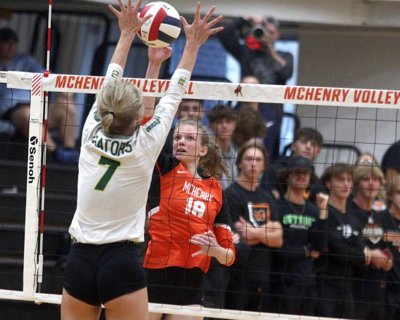 Crystal Lake South’s Gabby Wire, left, and McHenry’s Ella Boland battle at the net in varsity volleyball at McHenry Tuesday night.