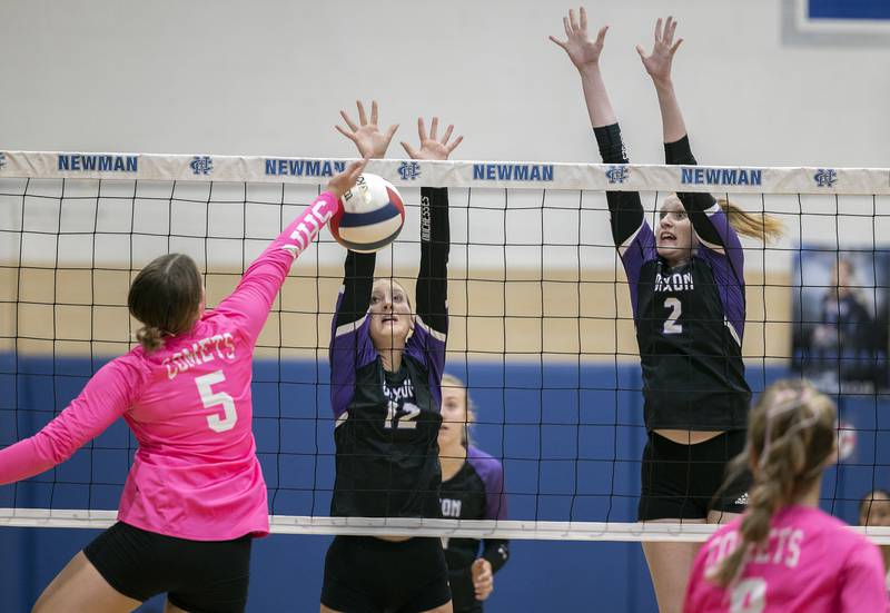 Dixon’s Isabelle Quackboerner (left) and Madyson Tichler go up for a block against Newman’s Lucy Oetting Thursday, Oct. 3, 2024, at Newman High School.