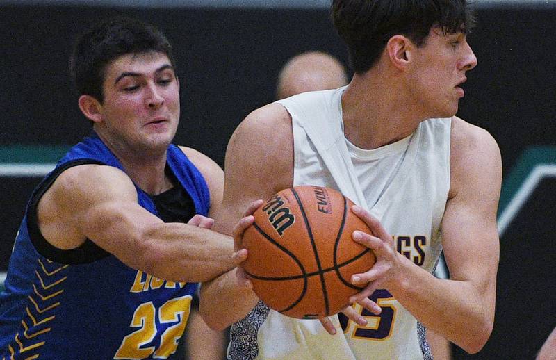 John Starks/jstarks@dailyherald.com
Lyon’s Carter Reid reaches for the ball held by Rolling Meadow’s Tsvet Sotirov in the Jack Tosh boys basketball tournament at York High School in Elmhurst on Friday, December 30, 2022.