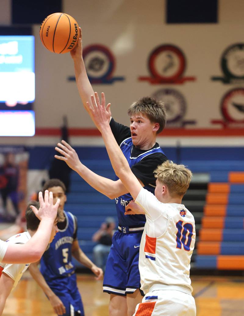 Hinckley-Big Rock's Judah Miceli passes the ball over Genoa-Kingston's Trevor Rhoads Tuesday, Jan. 6, 2026, during their game at Genoa-Kingston High School.