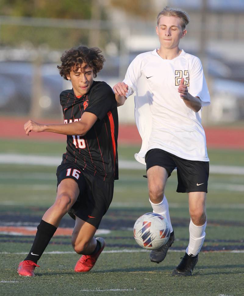 DeKalb's Miguel Berrocal (left) and Sycamore's Jack Wilson chase down the ball during their game Tuesday, Oct. 4, 2022, at DeKalb High School.