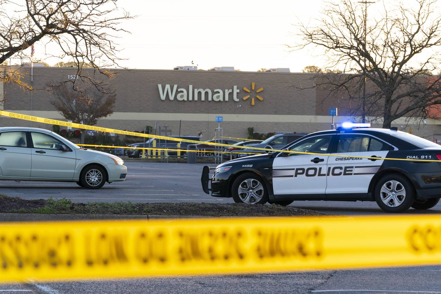 Law enforcement work the scene of a mass shooting at a Walmart, Wednesday, Nov. 23, 2022, in Chesapeake, Va.  The store was busy just before the shooting Tuesday night with people stocking up ahead of the Thanksgiving holiday.    (AP Photo/Alex Brandon)