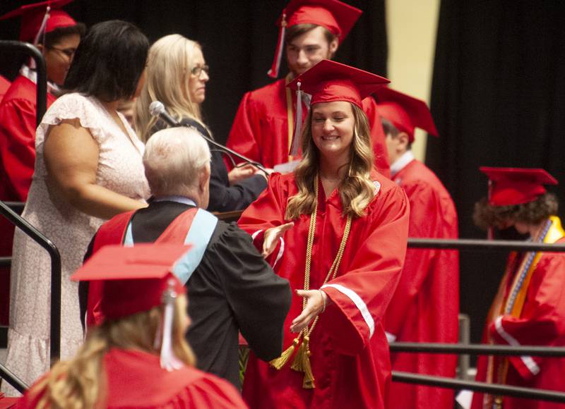 Graduate Saige Alexandra Avery receives her diploma during Yorkville High School's class of 2022 graduation ceremony at the NIU Convocation Center on Friday, May 20, 2022.