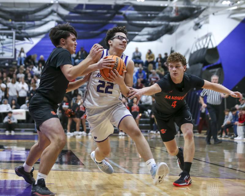 Plano's Jayden Zepeda (22) splits the defense during their basketball game between Sandwich at Plano Tuesday, Dec 9, 2025 in Plano.