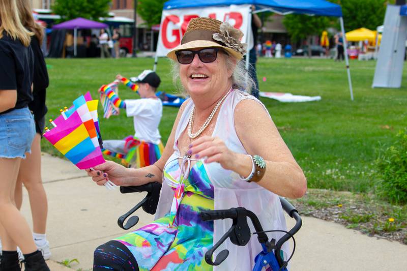 Parader waves pride flags on Saturday, June 8, 2024 at Jordan Block Park in Ottawa.
