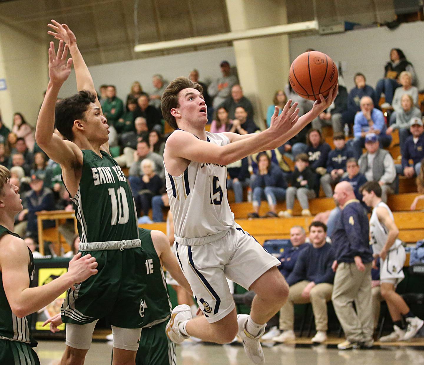 Marquette's Tommy Durdan runs in the lane to score over St. Bede's Isaiah Hart in the Class 1A Regional semifinal on Wednesday, Feb. 22, 2023 at Midland High School.