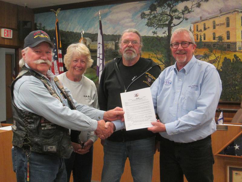 Pictured is Mike Rennels (right), Mayor of Plano, with Open Roads ABATE members Cliff Oleson, Patti & Kevin Smith with a signed proclamation proclaiming that May is Motorcycle Awareness Month at the April 22 Plano City Council Meeting.