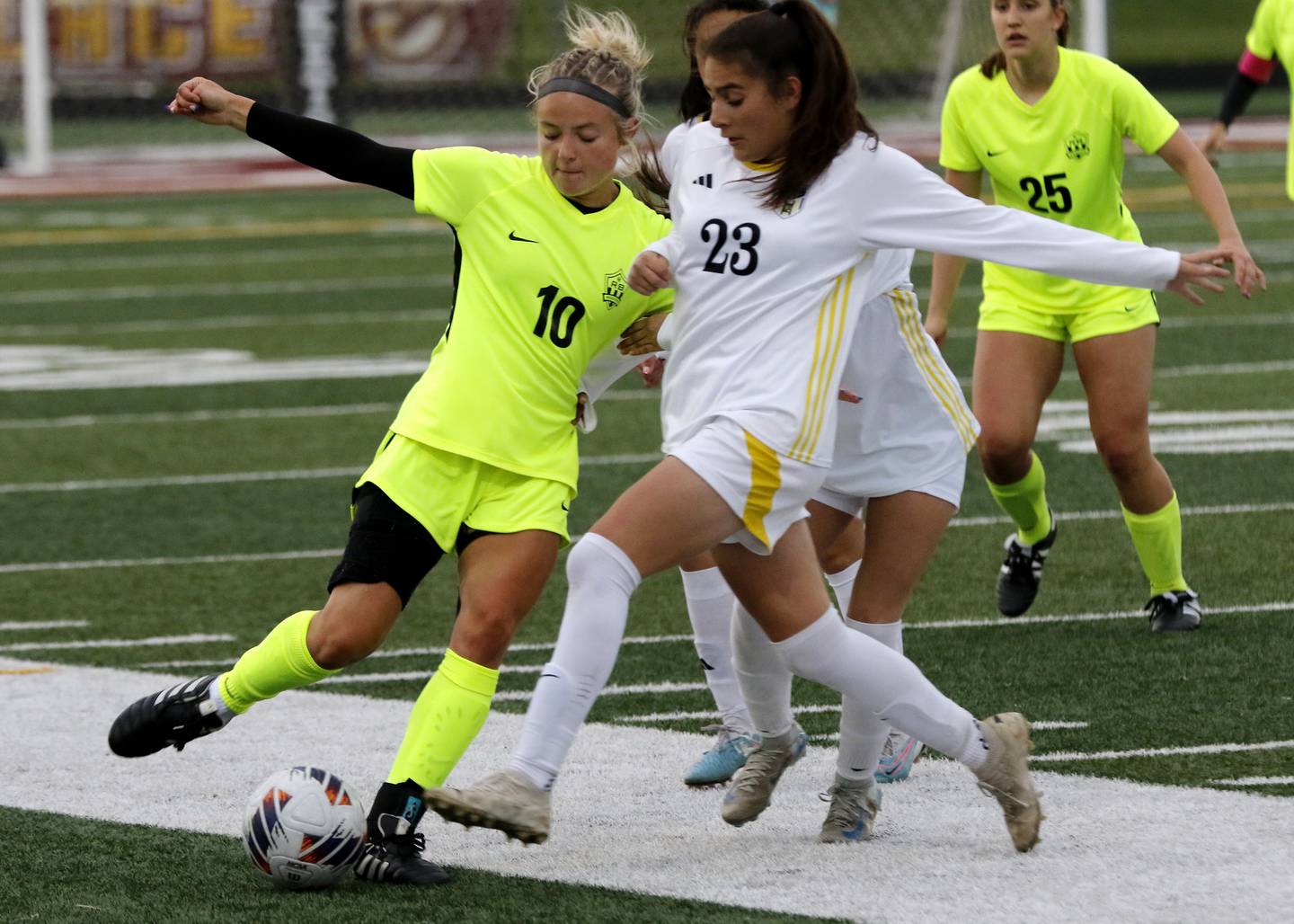 Richmond-Burton's Madelyn Seyller kicks the ball as she is defended by Harvard's Julie Silva during the Kishwaukee River Conference Girls Soccer Tournament Championship Match on Wednesday, May 7, 2025, at HRichmond-Burton High School in Richmond.
