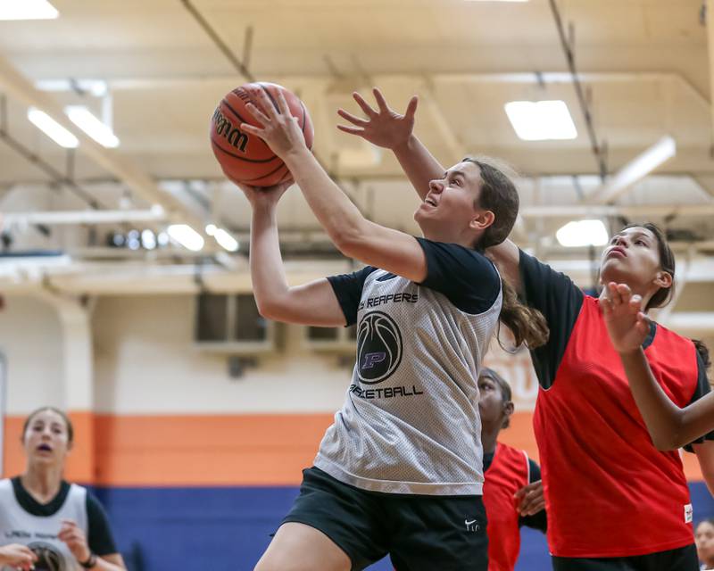 Plano's Josie Larson goes up for a layup at the Oswego girls basketball shootout tournament. June 28, 2024.