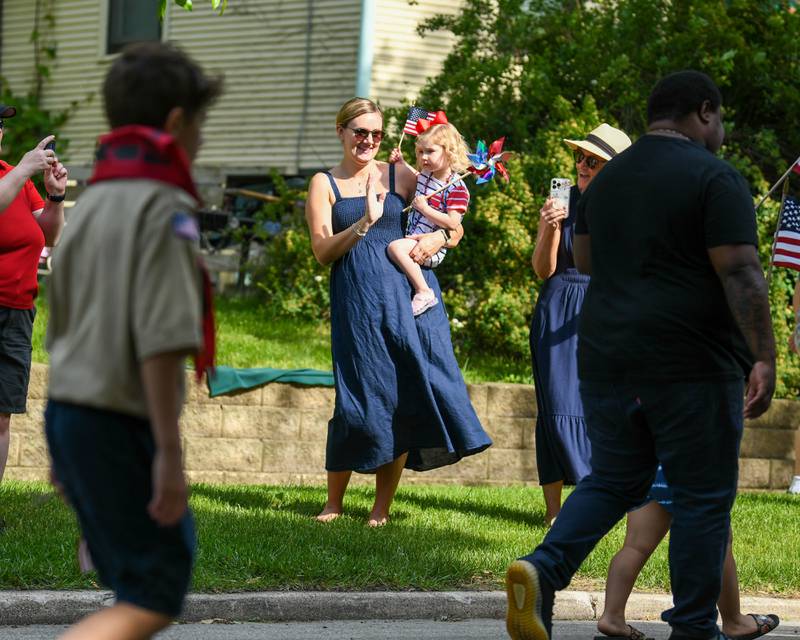 Jessica Antonacci holds her 2 year old daughter Ayla of DeKalb as they watch the boy scouts walk by during the Memorial Day parade in DeKalb on Monday May 30th.