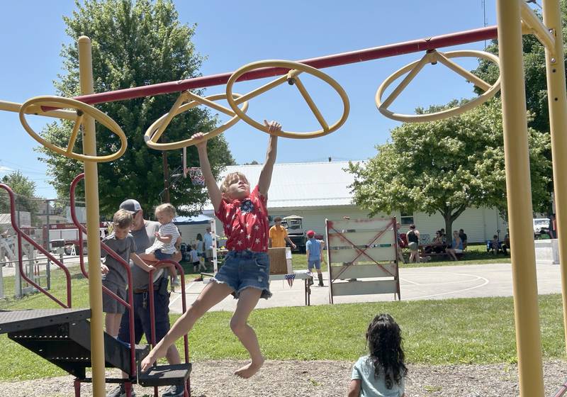 Charlotte Smith, 7, of Annawan-Hooppole, swings from the playground equipment during Hooppole Fun Day on Saturday, June 28, 2025 in Hooppole.