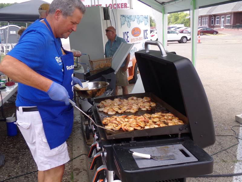 Joe Park grills shrimp Saturday, June 3, 2023, for the Shrimp and Brew Hullabaloo at Rotary Park in Princeton.