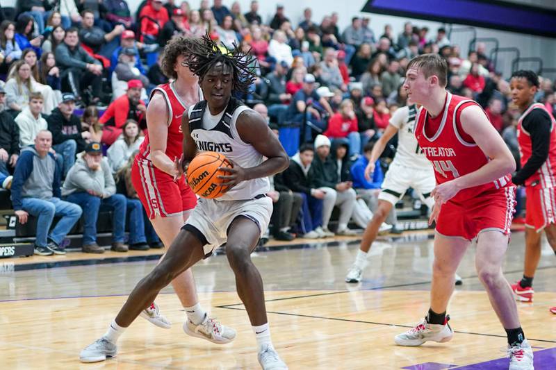 Kaneland's Freddy Hassan (5) plays the all in the post against Streator during a semi-final basketball game in the 61st annual Plano Christmas Classic at Plano High School on Friday, December 27, 2024.