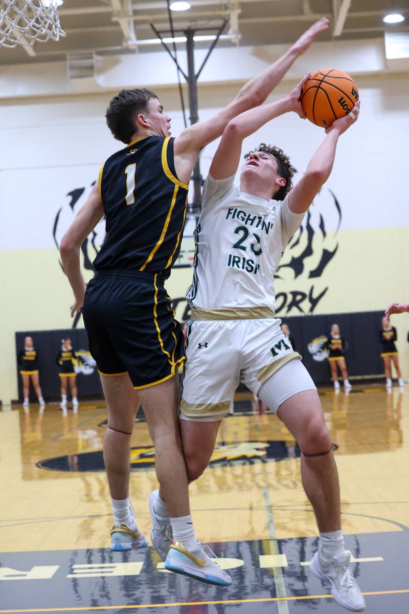 Bishop McNamara's Karter Krutsinger looks to shoot under pressure from Herscher's Tanner Jones during Bishop McNamara's 71-42 victory in the IHSA Class 2A Herscher Regional semifinal on Wednesday, Feb. 25, 2026.