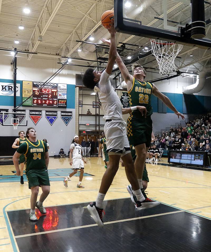 Crystal Lake South's Nick Stowasser blocks the shot of Kaneland's Evan Frieders during the IHSA Class 3A Woodstock North Sectional final basketball game on Friday, March 6, 2026, at Woodstock North High School.