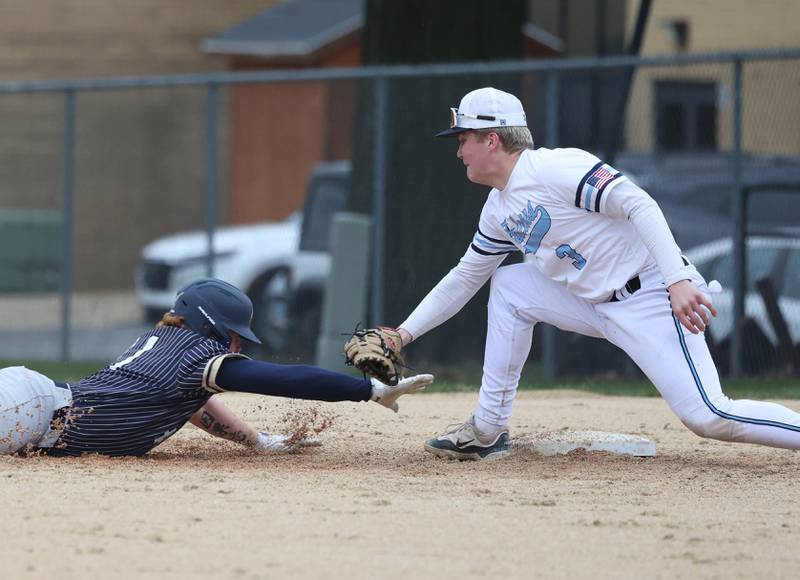 Parkview Christian Academy's Oliver Malkowski tags out a Hiawatha baserunner diving back to first Thursday, April 17, 2025, during their game at Hiawatha High School in Kirkland.