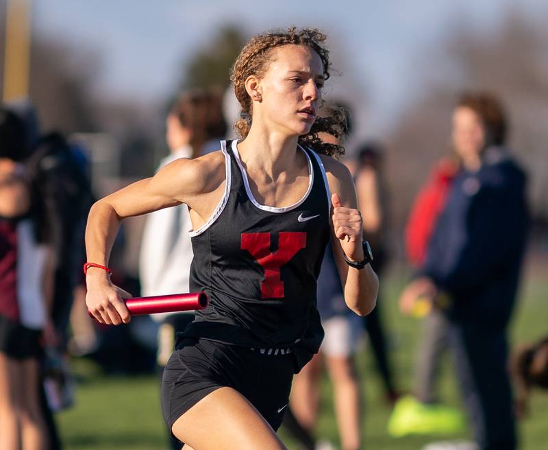 Yorkville’s Allegra Triner competes in the 4 x 800 meter relay race during the Matt Wulf Invitational track and field meet at Yorkville High School on Thursday, April 14, 2022.