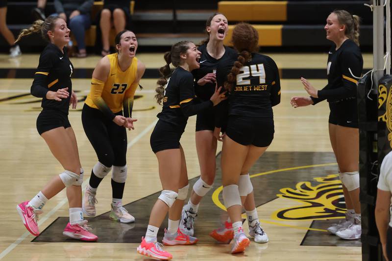 Joliet West’s Natalia Harris (24) is mobbed by teammate after her match point against Minooka on Tuesday, Sept. 26, 2023 in Joliet.