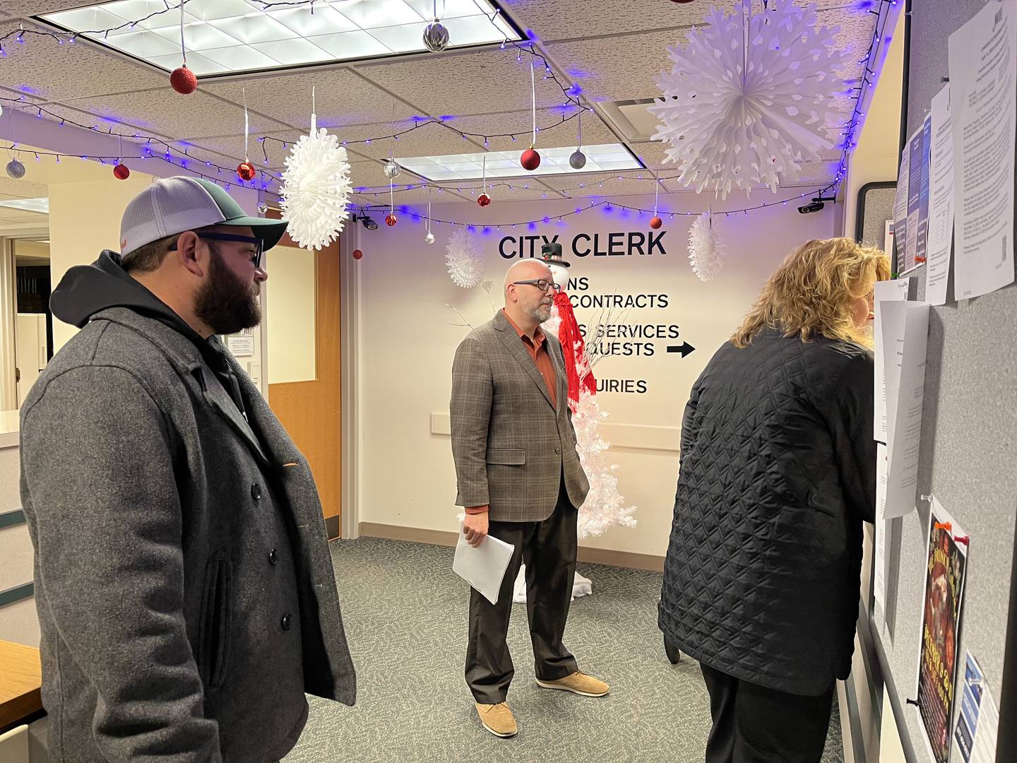 JR Patton (left), designee for Terry D'Arcy, Joliet mayor candidate, Quinn Adamowski, Joliet City Council District 2 candidate and Sherri Reardon, Joliet City Council District 3 candidate, appear the city clerk's office just before 8 a.m. on Monday to file candidacy petitions.
