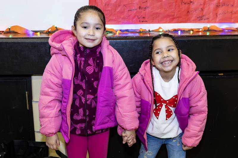 Jacquelyn Gomez Mendoza and Ariela Gomez show-off their new pink coats from Nicor Gas, in collaboration with Operation Warm, at T. E. Culbertson Elementary School on Nov. 7, 2025.