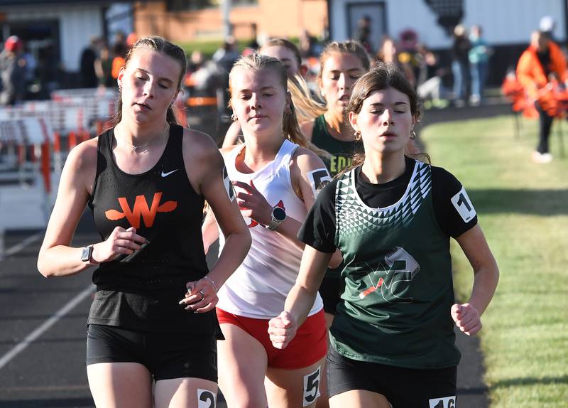 Oregon's Madeline Rogers (center) races Winnebago's Svea Gliddens (left) and West Carroll's Isabella Valdivia (right) early in the 3200 meter run at the 1A Winnebago Sectional on Wednesday, May 13, 2026. Rogers won the race and qualified for the state meet.