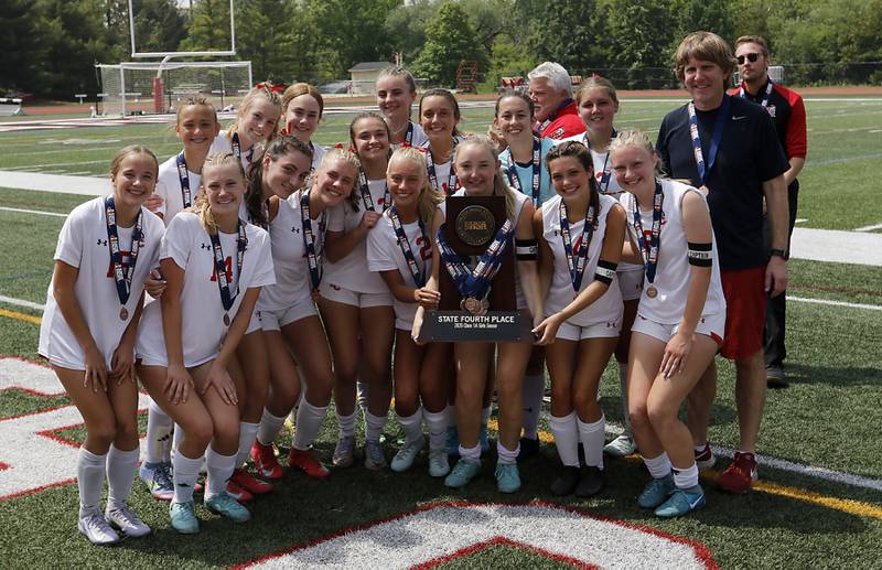 Timothy Christian players with their four place trophy after the IHSA Class 1A State Girls Soccer third-place match against Williamsville on Friday, June 6, 2025, at North Central College in Naperville.