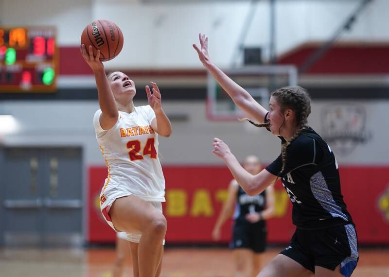 Batavia’s Hallie Crane (24) shoots the ball in the post against St. Charles North's Katrina Stack (22) during a basketball game at Batavia High School on Tuesday, Dec 5, 2023.