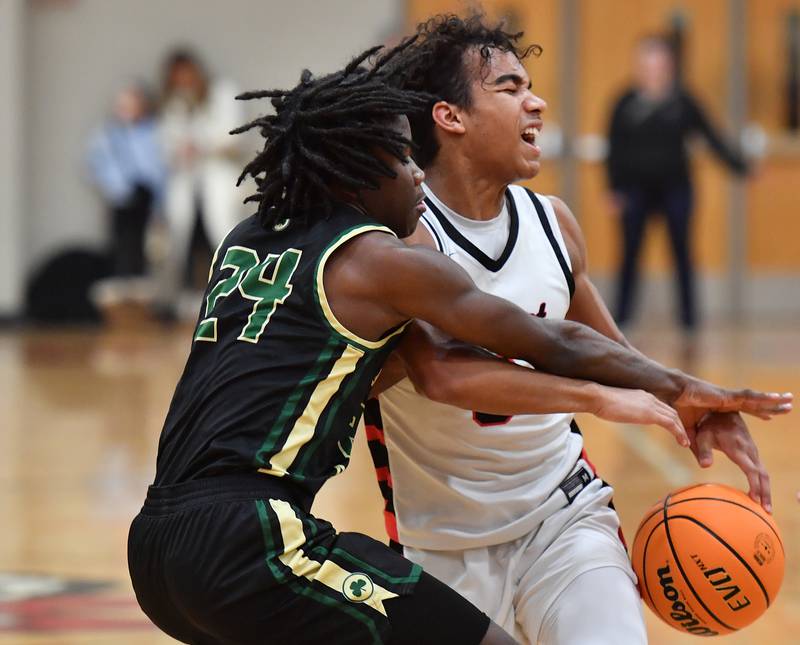Benet’s Blake Fagbemi is fouled by St. Patrick’s Maurice Neeley (24) during a game on January 17, 2025 at Benet Academy in Lisle.
