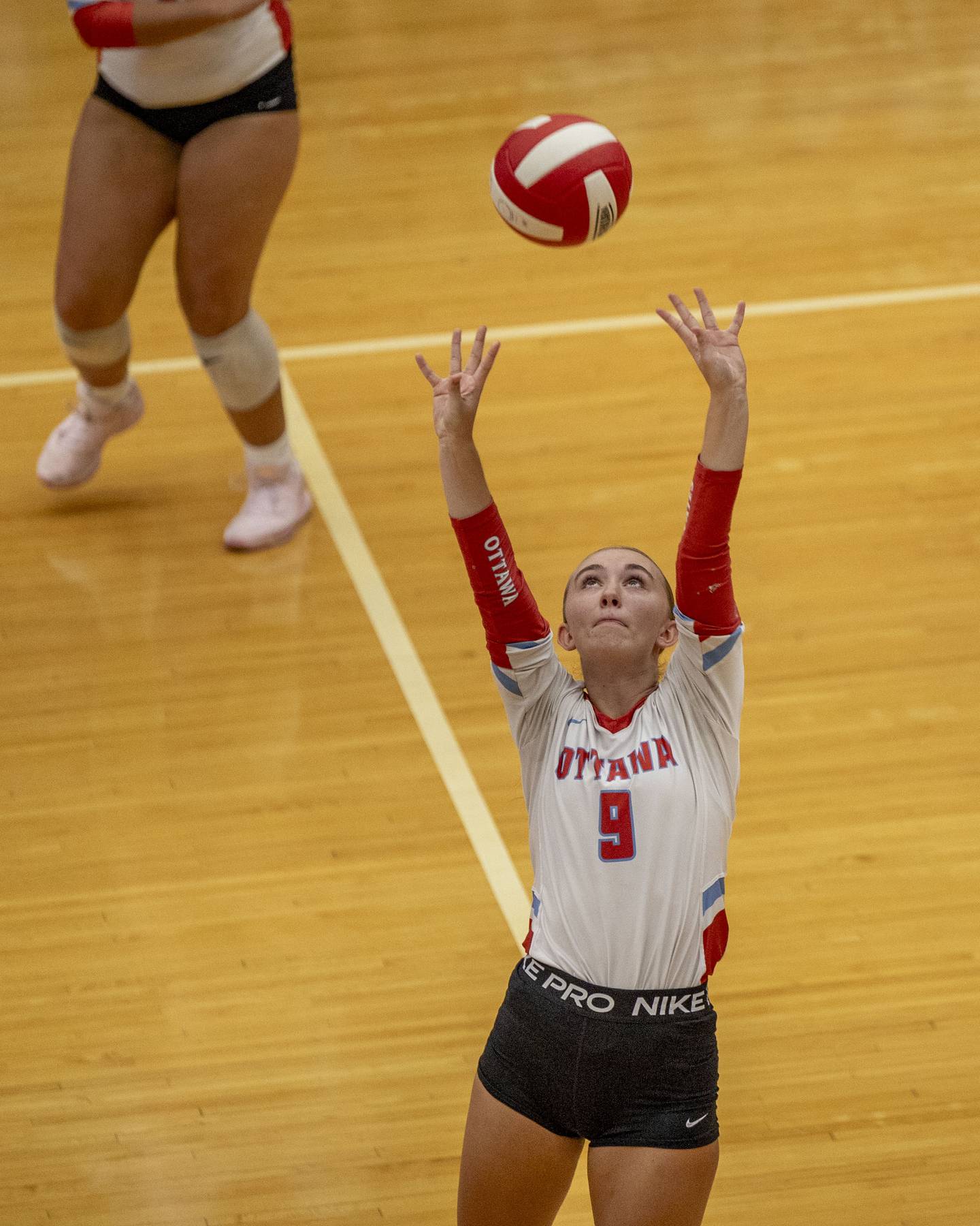 (from left) Ashlynn Ganiere (9) of Ottawa sets volleyball on Thursday, Sept. 18, 2025 at Ottawa High School in Ottawa.