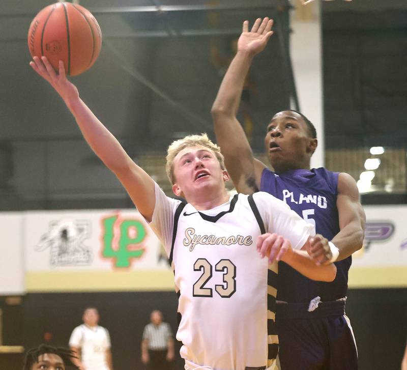 Sycamore's Carter York shoots around Plano's Waleed Johnson Tuesday, Jan. 3, 2023, during their game at Sycamore High School.