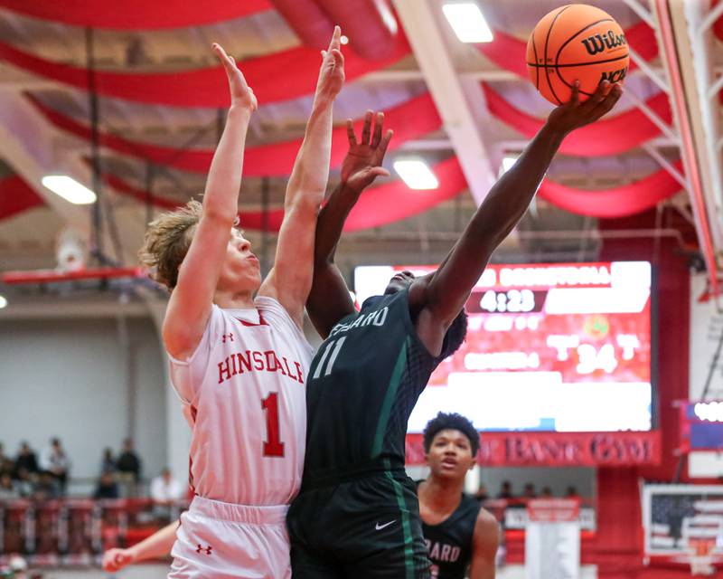 Glenbard West's Teyion Oriental (11) puts up a contested shot during their basketball game between Glenbard West at Hinsdale Central, Friday  Dec 6, 2024  in Hinsdale.