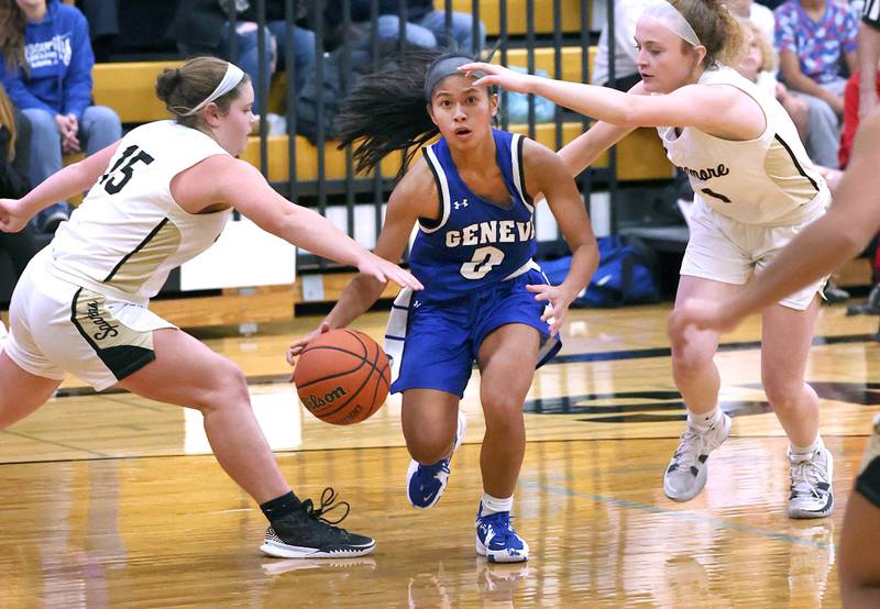 Geneva's Riley Hasegawa drives between Sycamore's Sophia Klacik (left) and Sycamore's Mallory Armstrong during their game Monday, Nov. 14, 2022, at Sycamore High School.