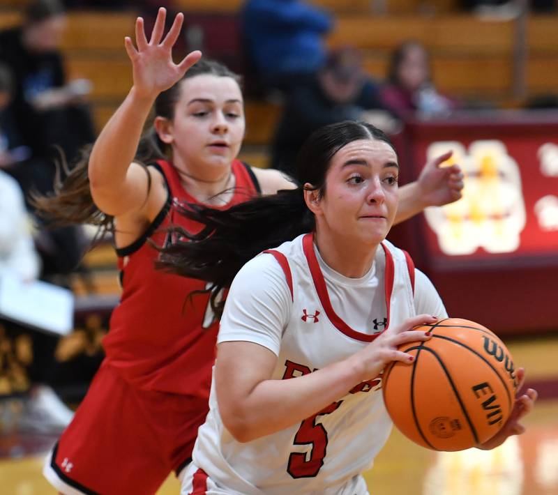 Benet’s Ava Thomas (5) starts to pass after driving past Marist’s Olivia Cosme during the Montini Christmas Tournament championship game on December 27, 2025 at Montini Catholic High School in Lombard.