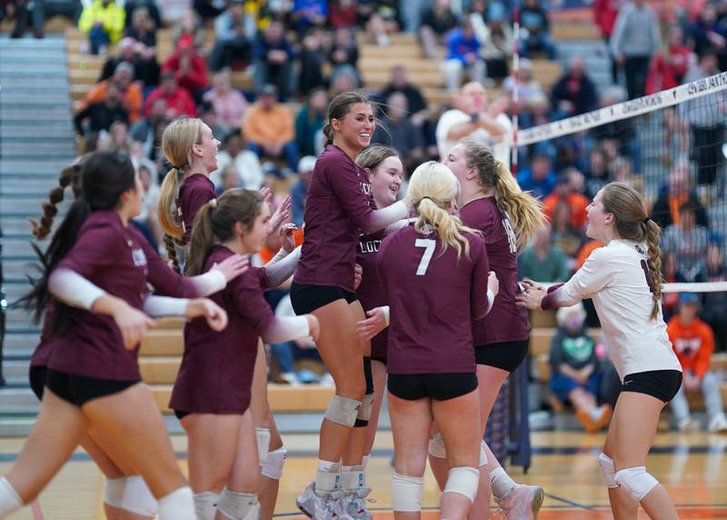 Lockport players celebrate after defeating Oswego in two sets to advance to the class 4A Oswego Sectional Final at Oswego High School on Monday, Oct. 30, 2023.