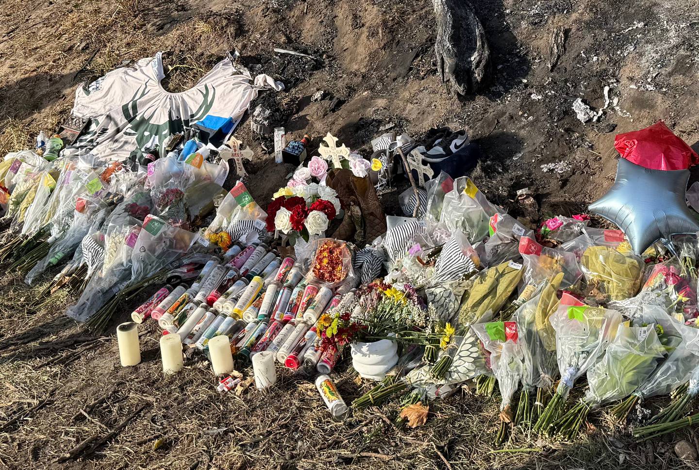 A makeshift memorial is in place Tuesday, Oct. 29, 2024, at the site of a crash that claimed three lives near Woodstock two days before.
