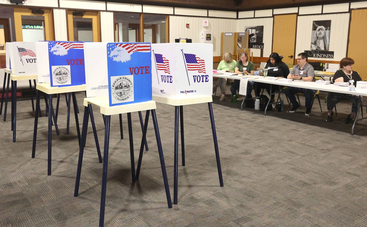 Election judges wait for the next voter to check in as voting booths remain idle during a slow period on election day Tuesday, June 28, 2022, at the polling place in Westminster Presbyterian Church in DeKalb.